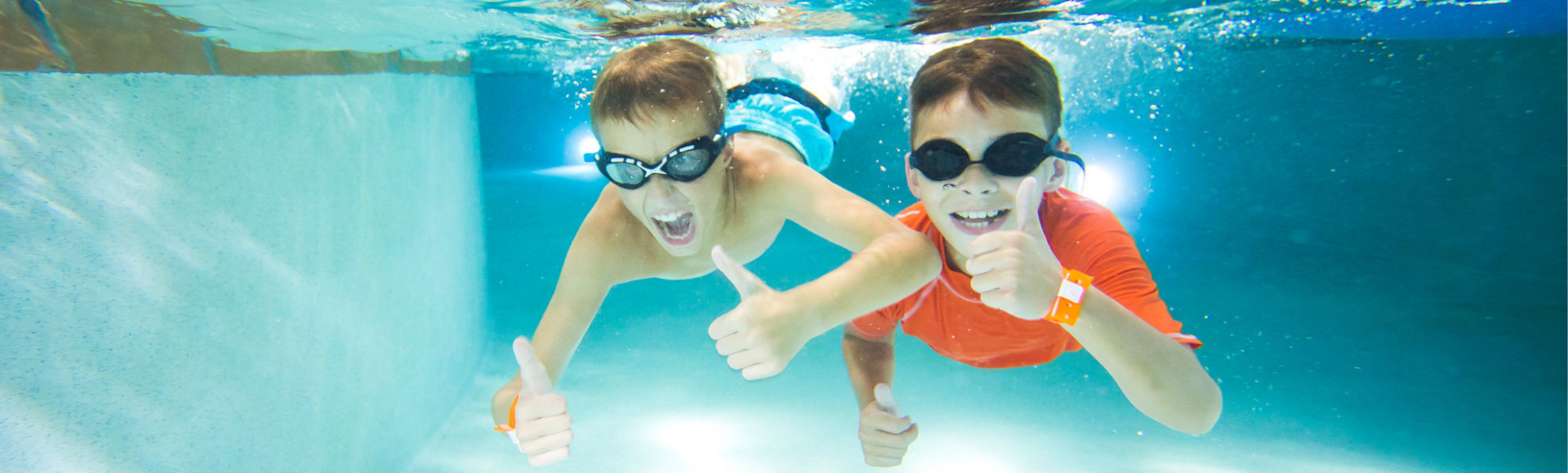 two kids swimming underwater